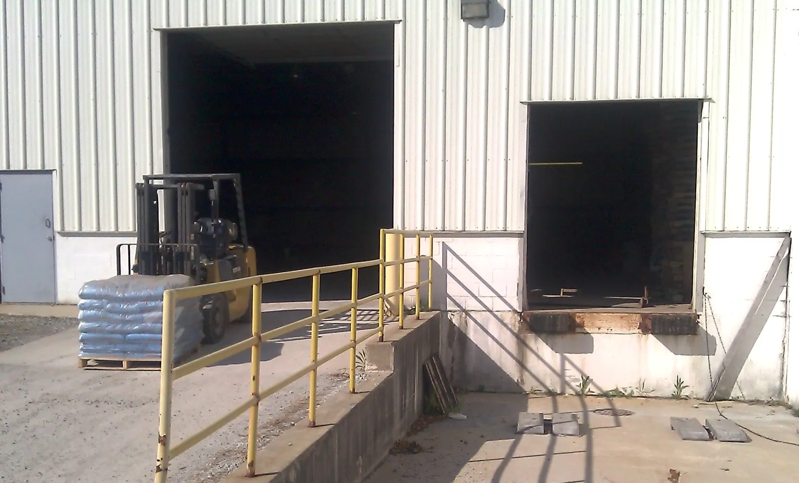 Loading dock with a forklift and a pallet of bagged material at the Krooswyk warehouse in Highland