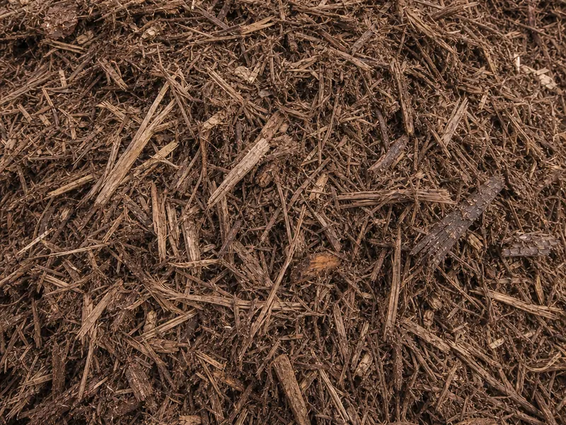 Close-up of shredded brown hardwood mulch (generic material photo)