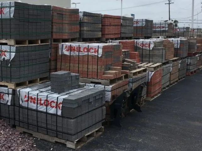Pallets of pavers and wall brick stocked in the Krooswyk yard
